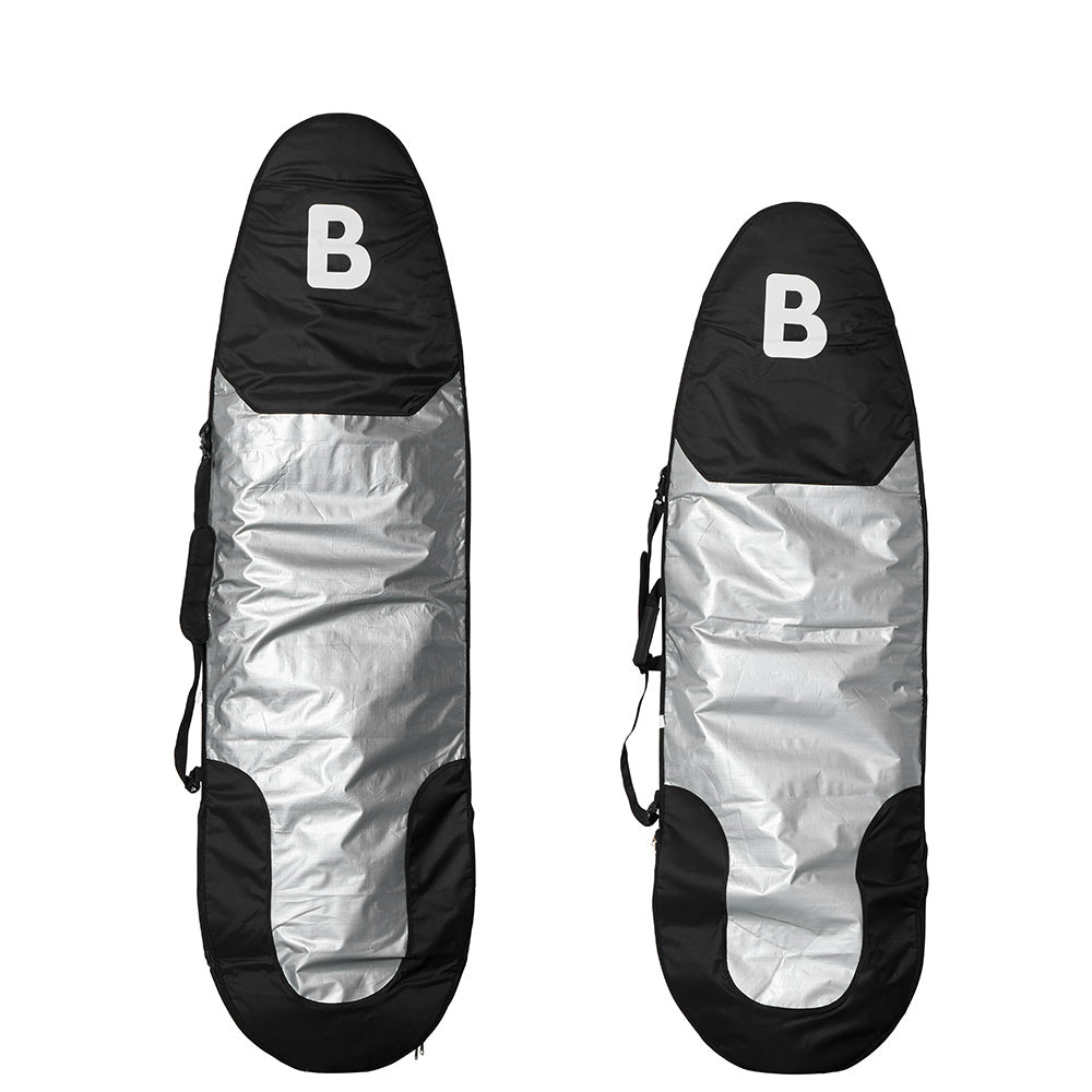 Two b surfboard carrying bags shown upright on a white background, each with a black top section featuring a white letter B, a reflective silver center, and black lower sections.
