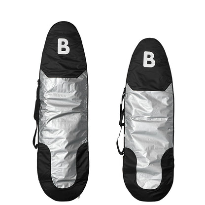 Two b surfboard carrying bags shown upright on a white background, each with a black top section featuring a white letter B, a reflective silver center, and black lower sections.